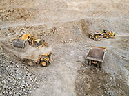 excavator & front loader loading 90 T trucks in pit