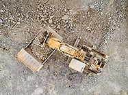 aerial vbiew | excavator loading 90 T truck in pit