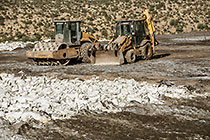 arsenic waste site | digger loader & roller compactor