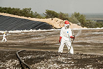 arsenic waste site | workers moving water sprayers