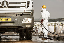 arsenic waste site | worker water cleaning truck