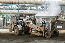 truck taking bucket with smelted ore for further processing