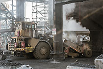 truck taking bucket with smelted ore for further processing