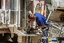 worker welding borehole casing near processing plant