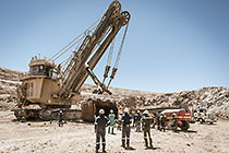 team changing bucket of rope shovel