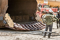 team changing bucket of rope shovel