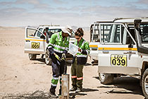 environmental field team taking borehole water sample