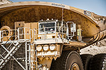 320 T truck driving on road | close up on driver