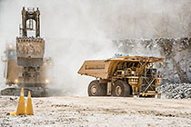 rope showel loading rocks into 320T truck in pit