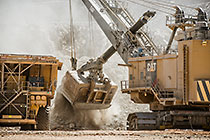 rope showel loading rocks into 320T truck in pit