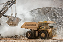 rope showel loading rocks into 320T truck in pit