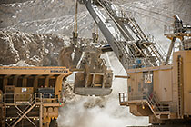 rope showel loading rocks into 320T truck in pit