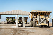 workers & 320 T trucks at diesel filling station