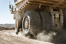 320 T truck leaving diesel filling station | close up on wheels