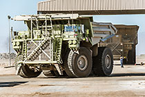 workers & 320 T trucks at diesel filling station