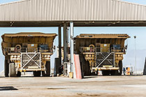 workers & 320 T trucks at diesel filling station