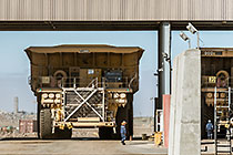 workers & 320 T trucks at diesel filling station