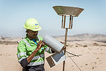 environmental monitoring assistant Immanual taking sample from dust collector