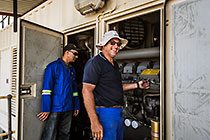 Jacques Van Wyk & electrician checking diesel generators