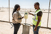 environmental scrientist Kaarina Nkandi taking fresh water sample at boreole