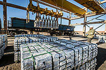 worker loading zinc bricks onto truck
