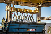 worker loading zinc bricks onto truck