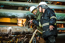 foundry | workers checking liquid zinc flowing in chanel