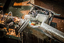 foundry | burning torch on wheel to make zinc bricks