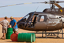 pilots re-fuellling helicopter before take-off