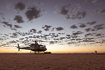 helicopter taking off at sunrise