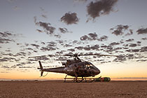 helicopter taking off at sunrise