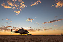 helicopter taking off at sunrise