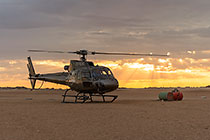 helicopter taking off at sunrise