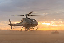 helicopter taking off at sunrise