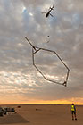 helicopter taking off with SkyTEM rig at sunrise