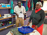 lady showing bathik & dolls to Elias & Lisa