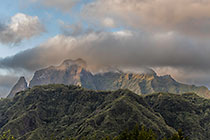 mountain peaks under clouds at sunset