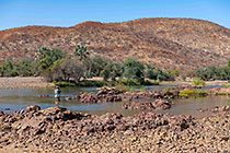 Paul taking photo of rocks in Kunene river