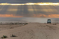 disco driving in sandy pain at sunset