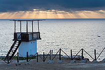 observatory on ocean seashore at sunset