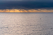 boat in ocean at sunset