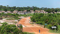 people on bridge next to village