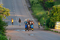 people & tricycle on road