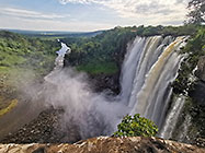 waterfall & river between green vegetation