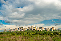 huge granite boulders between green vegetation