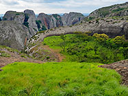 huge granite boulders between green vegetation
