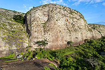 ranger-camper at campsite near huge granite boulders between green vegetation