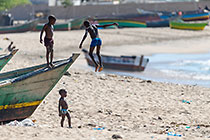 children playing on boat on beach