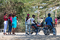 women & men on motorcycles under tree