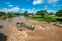 people bathing & washing clothes in river